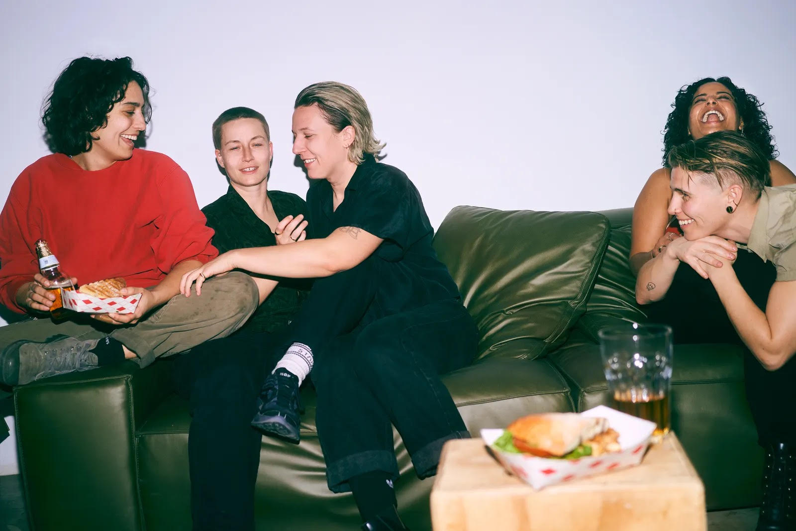 People Sitting On Couch With Sandwich